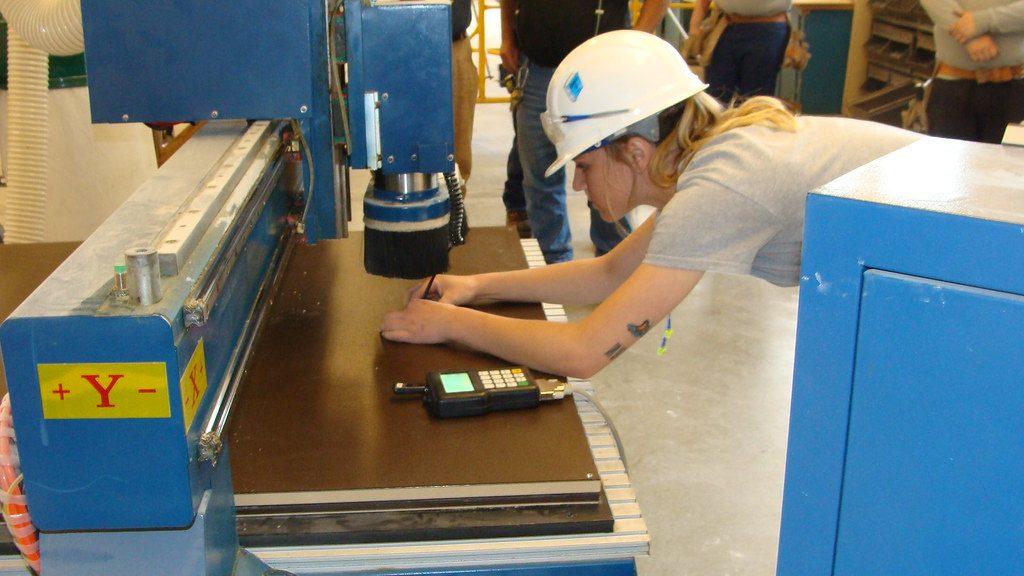 CNC router machine cutting a wooden sheet