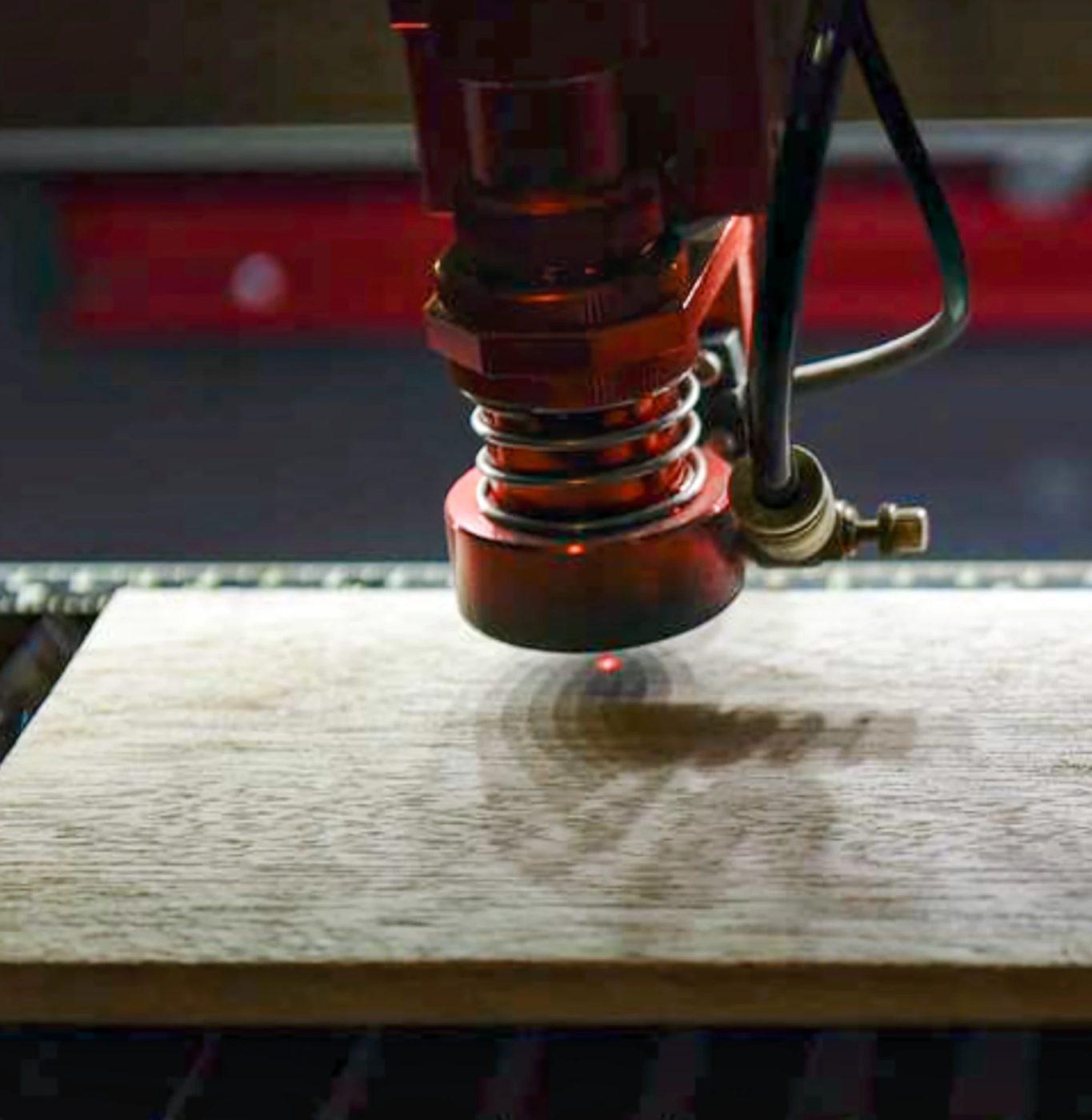 Laser engraving a design onto a wooden board